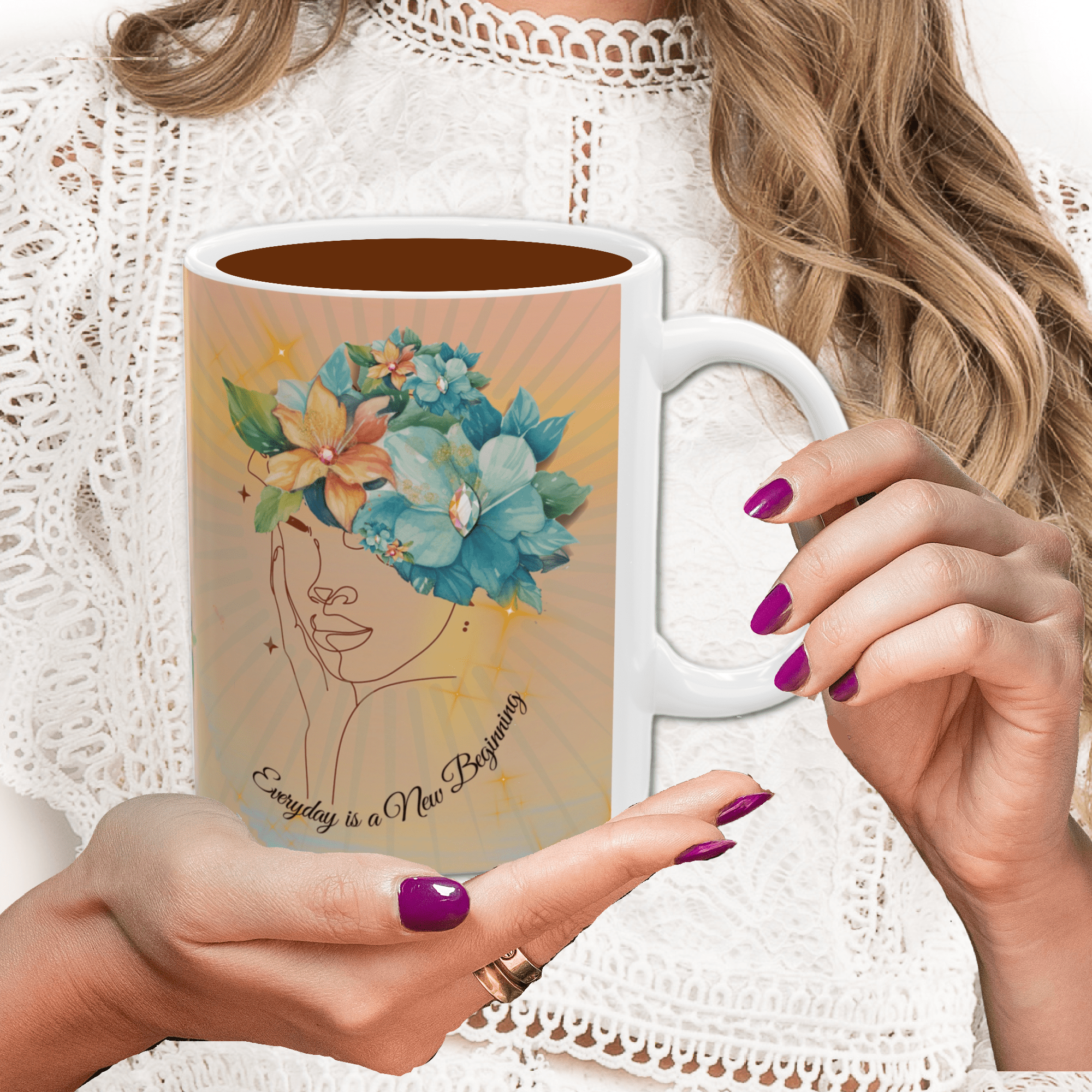 person holding a ceramic mug with inspirational saying "everyday is a new beginning"