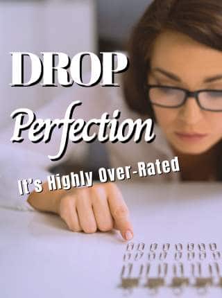 A woman wearing glasses is closely examining a row of miniature chairs arranged neatly on a table. Overlaid text reads: "DROP Perfection – It's Highly Over-Rated.